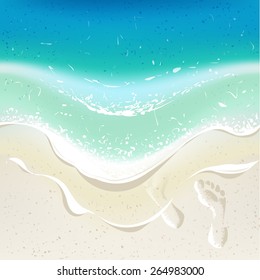 Sea wave on a tropical beach. Footprints on sand. Background for summer time holiday design.