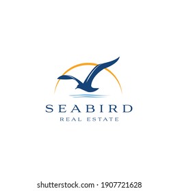 Seabird real estate logo design. Seagull luxury property template vector symbol. Sea Bird fly silhouette sign