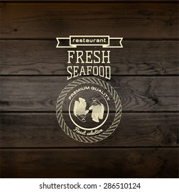 Seafood badges logos and labels for any use. On wooden background texture