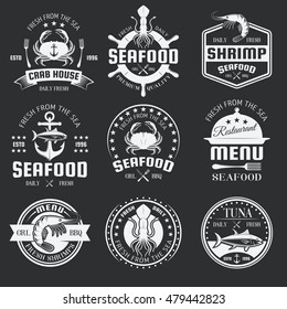 Seafood monochrome emblems of restaurants and shop with underwater animals on black background isolated vector illustration