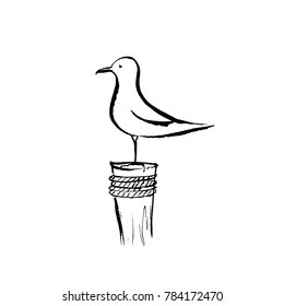 Seagull sitting on a wooden pole.
