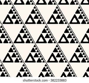 Seamless abstract decorative background.  Repeating geometric tiles from triangles of various size.