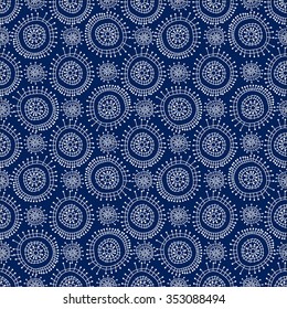 Seamless abstract geometric pattern in doodle style. White snowflakes on blue background, hand drawn, vector. For background design and decoration, wallpaper, packaging, fabrics, textiles.