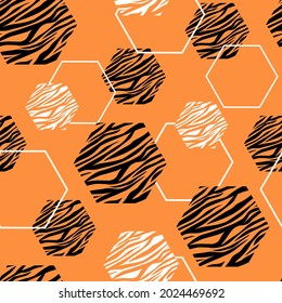 Seamless abstract geometric pattern. Hexagons with an ornament of tiger stripes. The symbol of the eastern new year. Vector graphics.