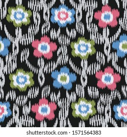 Seamless abstract ikat pattern with the image of floral ornament.
