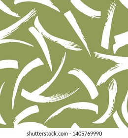 Seamless abstract marks pattern with handmade brushstroke elements on green background.
