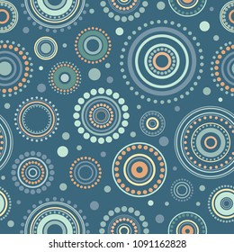 Seamless abstract pattern of circles and dots of blue, orange and turquoise colors. Kaleidoscope background. Decorative wallpaper, good for printing. Vector illustration. Ethnic style