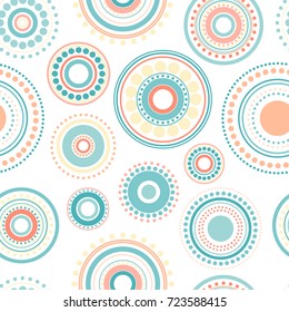 Seamless abstract pattern of circles and dots of orange and turquoise colors on white background. Kaleidoscope background. Decorative wallpaper, good for printing. Vector illustration. Ethnic style