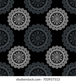 Seamless abstract pattern with geometrical round mandalas in folk style. Croatian ethnic motifs. White and gray lines and dots on black background.