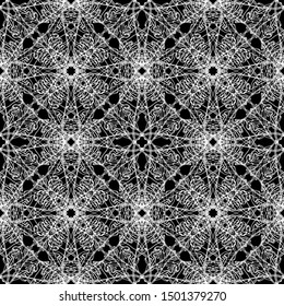 Seamless abstract pattern. Imitation lace. White lace on black background. Black and white graphics. For design and decoration of fabric, paper, Wallpaper and packaging.Mesh pattern.