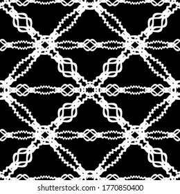 Patrón abstracto sin inconvenientes. Imitación de encaje. Lazo blanco sobre fondo negro. Gráficos en blanco y negro. Para el diseño y la decoración de tela, papel, papel pintado y embalaje.Patrón de malla. 