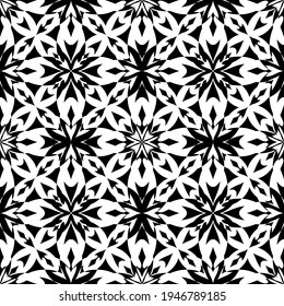 Patrón abstracto sin inconvenientes. Imitación de encaje. Lazo blanco sobre fondo negro. Gráficos en blanco y negro. Para el diseño y la decoración de tela, papel, papel pintado y embalaje.Patrón de malla.