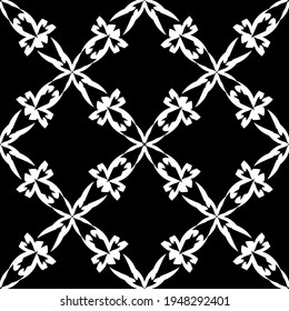 Seamless abstract pattern. Imitation lace. White lace on black background. Black and white graphics. For design and decoration of fabric, paper, Wallpaper and packaging.Mesh pattern.