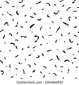 Seamless abstract pattern of little black shabby scratches or spots on white. Hand drawn, offhand style. Grained surface. Vector texture with particles of debris.  Vector black and white ornament