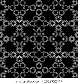 Seamless abstract pattern. On a black background an ornament of white lace rings. Vector illustration.