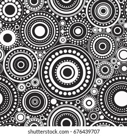 Seamless abstract pattern of white circles and dots on black background. Kaleidoscope background. Decorative wallpaper, good for printing. Vector illustration. Ethnic style.