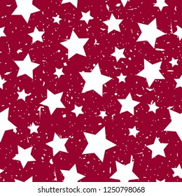 Seamless abstract pattern with white stars of different rotation and size. Grunge star red background. Vector Christmas illustration. Magic holiday texture with particles of debris