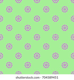 Seamless abstract polka dot pattern with round floral motifs. Pink on green background.