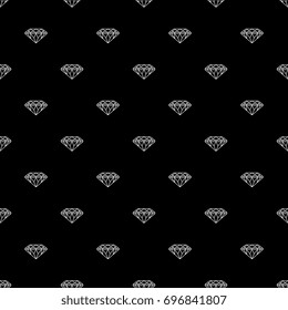 Seamless abstract small geometrical pattern with faceted diamonds. White silhouetted outlines on black background.
