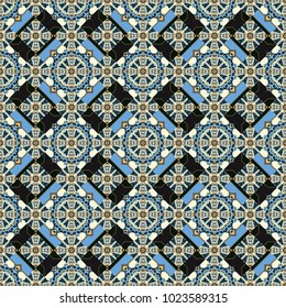 Seamless abstract vector geometric pattern. Symmetrical layout. Colorful ethnic patterned background in blue, gray and beige colors. Bed sheets and interior. Gift wrapping paper.