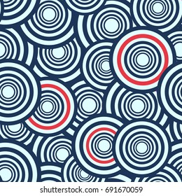 Seamless abstract vector geometric pattern. White, blue and red circles covering each other.