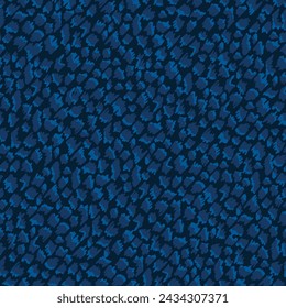 Seamless abstract vector pattern. Repeating print with a tonal blue painted design on a navy blue background. Apparel textile print.
