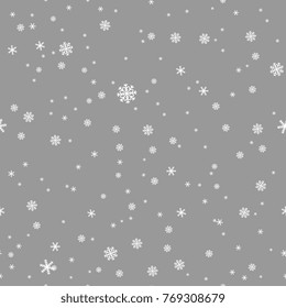 Seamless abstract winter pattern with snowflakes on silver background.
