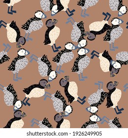 Seamless abstract zoo life pattern with simple puffin birds ornament. Beige background. Ornithology backdrop. Flat vector print for textile, fabric, giftwrap, wallpapers. Endless illustration.