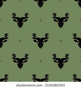 Seamless animal pattern with heads of a goat or antelope with twisted horns. Animal face mask. Ancient Sumerian sculpture. On green background.