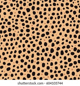 Seamless animal pattern. Imitation print of skin of cheetah. Black and brown spots on brown background.