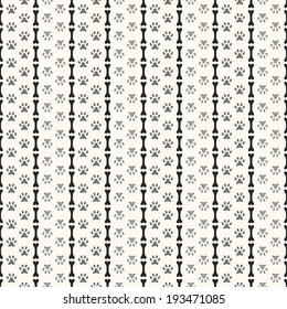 Seamless animal pattern of paw footprint and bone. Endless texture can be used for printing onto fabric, web page background and paper or invitation. Parallel dog style. White and black colors.