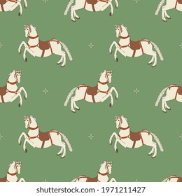 
Seamless animal pattern with running saddled white horses. Folk style. On green background.