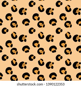 Seamless animalistic vector pattern on beige background. Hand drawn black and orange leopard spots. Perfect for wallpaper or fabric.