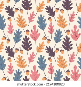 Seamless autumn pattern of acorns and oak leaves on a beige background in warm palette. For textile, wrapper, background.