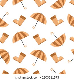 Seamless autumn pattern with brown yellow rubber boots and an umbrella for rainy weather in a flat style isolated on a white background