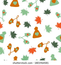 Seamless autumn pattern. Orange and green hats, mittens and maple leaves on a white background. The print is suitable for packaging.