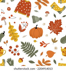 Seamless autumn pattern with sweater, hat, pumpkin and yellow leaves. Fabric print on a white background.