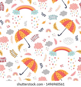 Seamless autumn pattern with umbrellas, clouds with rain and rainbows. Bright repeated texture for fall season. Wrapping paper. Autumn background with leaves, rain drops, clouds