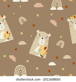 Seamless background with autumn bear. Cute animal with a bouquet of autumn leaves on a brown background with a rainbow and clouds. Vector illustration. Scandinavian style for design