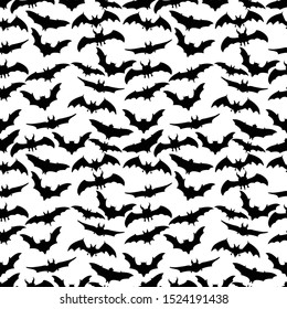 Seamless background with bats for Halloween greetings. Vector illustration with wild flying creatures. Monochrome seamless pattern with soaring bats on a white background for decoration on Halloween.