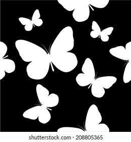 Seamless background of black and white butterflies. Vector