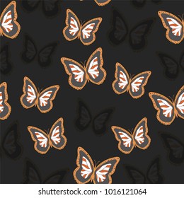 Seamless background from bright butterflies. Beautiful colorful butterflies chaotically fly. Seamless multicolored background with flying moths. Suitable for fabric, paper, packaging.