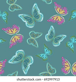 Seamless background from bright butterflies. Beautiful colorful butterflies chaotically fly. Seamless multicolored background with flying moths. Suitable for fabric, paper, packaging.