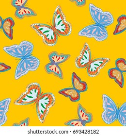 Seamless background from bright butterflies. Beautiful colorful butterflies chaotically fly. Seamless multicolored background with flying moths. Suitable for fabric, paper, packaging.