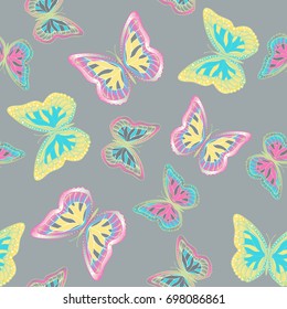 Seamless background from bright butterflies. Beautiful colorful butterflies chaotically fly. Seamless multicolored background with flying moths. Suitable for fabric, paper, packaging.