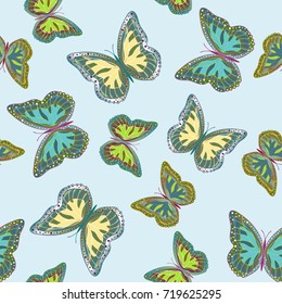 Seamless background from bright butterflies. Beautiful colorful butterflies chaotically fly. Seamless multicolored background with flying moths. Suitable for fabric, paper, packaging.