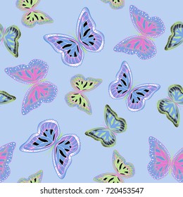 Seamless background from bright butterflies. Beautiful colorful butterflies chaotically fly. Seamless multicolored background with flying moths. Suitable for fabric, paper, packaging.