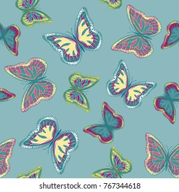 Seamless background from bright butterflies. Beautiful colorful butterflies chaotically fly. Seamless multicolored background with flying moths. Suitable for fabric, paper, packaging.