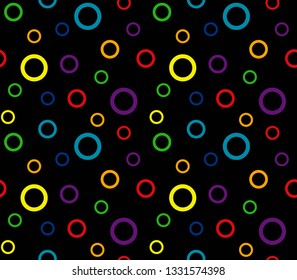 Seamless background. Bright rings on the black background. Rainbow color. Vector illustration