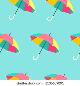 Seamless background with bright summer striped umbrellas. Vector illustration on blue background.